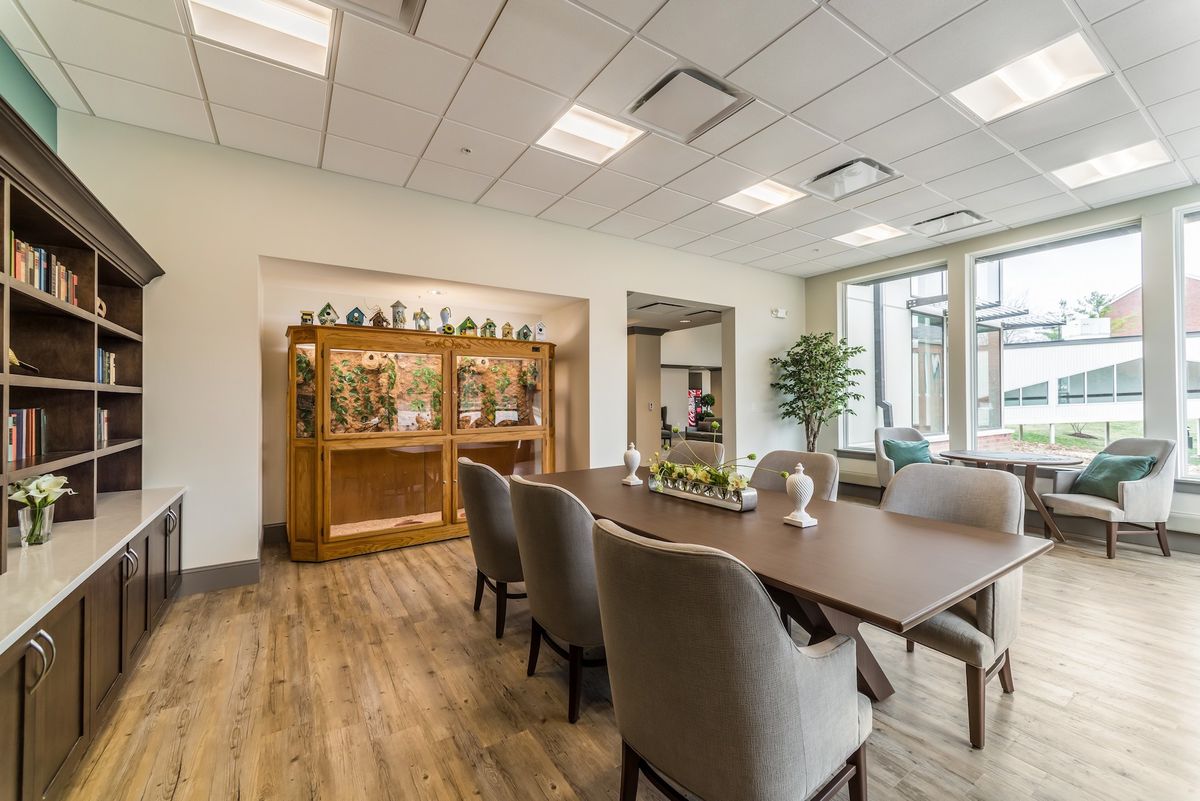 Interior view of Gambrill Gardens senior living community, featuring a dining room with elegant furniture and hardwood floors.