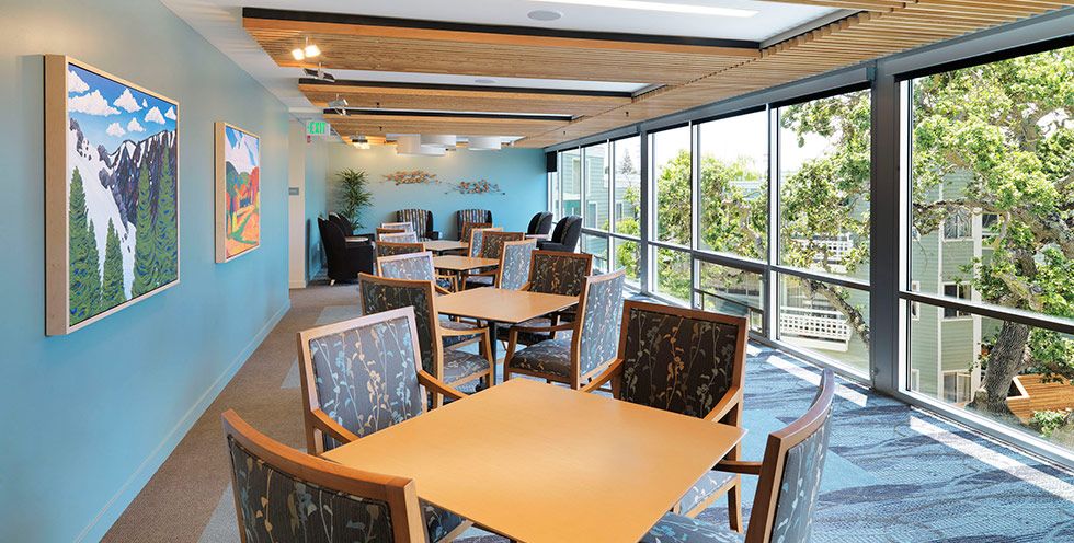 Interior view of The Avant at Palo Alto Commons featuring dining area, art, and architecture.