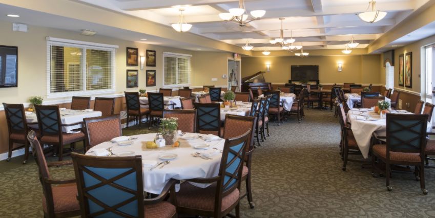 Senior living community dining room at Encore at the Lodge with elegant furniture and decor.