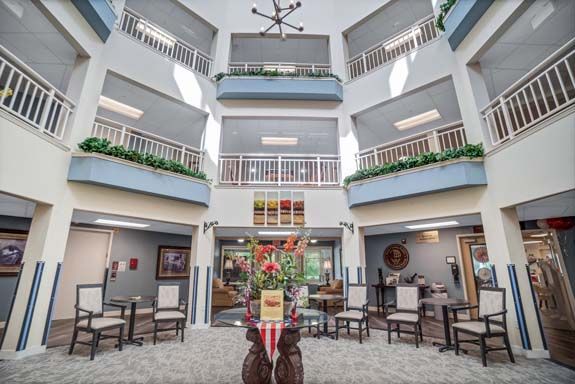 Senior living community Rittenhouse Village Gahanna featuring dining room, city view, and urban architecture.