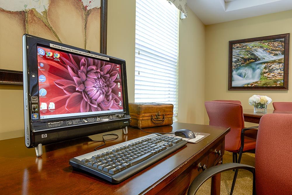 Senior living community Greystone Farm at Salem featuring a furnished computer desk with PC and hardware.