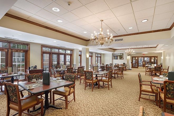 Interior view of Brookdale Monroe senior living community featuring dining room with furniture.