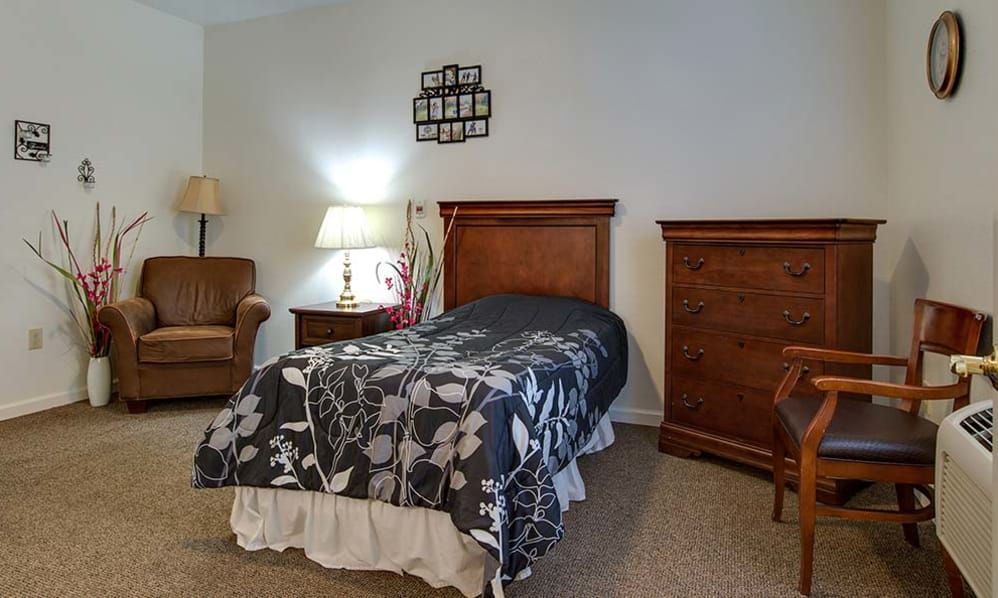 Interior design of a bedroom in Hickory Gardens senior living community with elegant furniture.