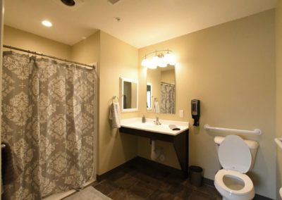 Interior view of a well-equipped bathroom in a room at Hampton Manor of Shelby senior living community.