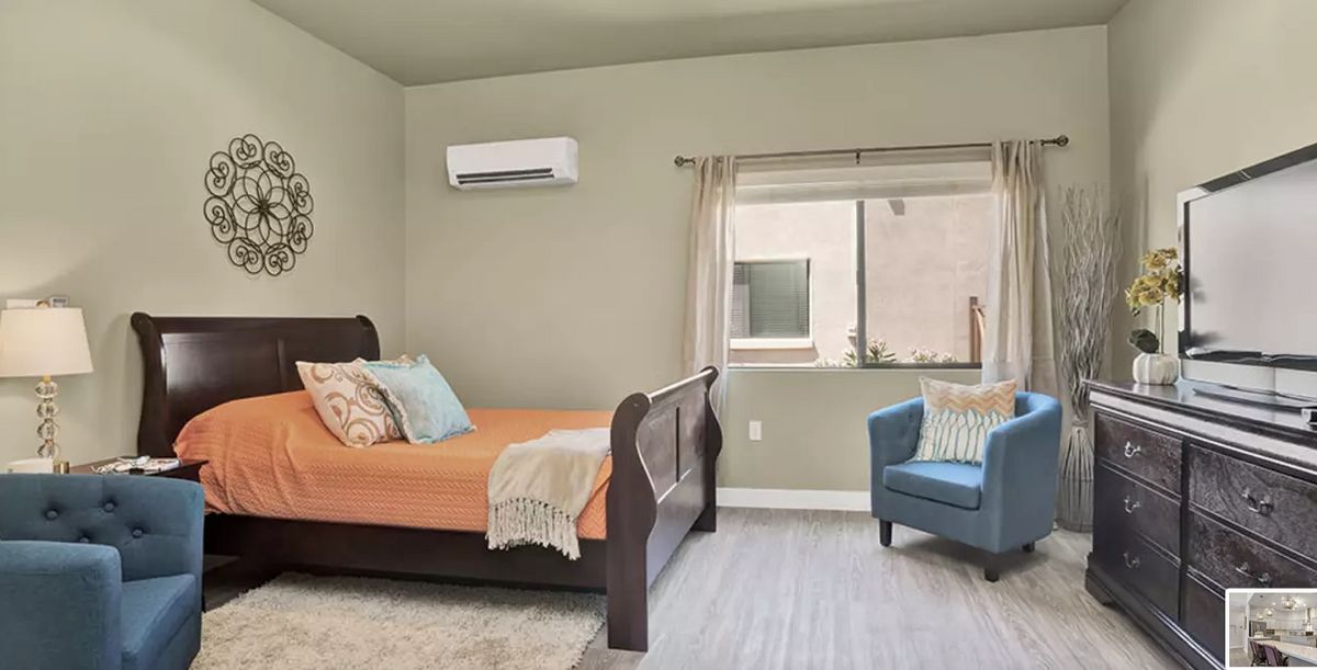 Interior view of a well-decorated bedroom with modern furniture at Hacienda Del Rey senior living community.