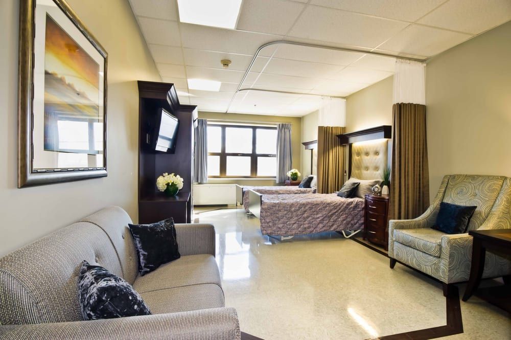 Senior living room at Aperion Care International with cozy furniture and art decor.
