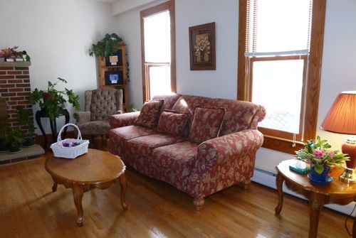 Interior view of Sun Valley senior living room at The Homestead, featuring cozy furniture and decor.