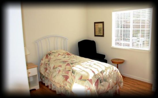 Interior view of Hercules senior living community featuring bedroom decor, furniture, and art.