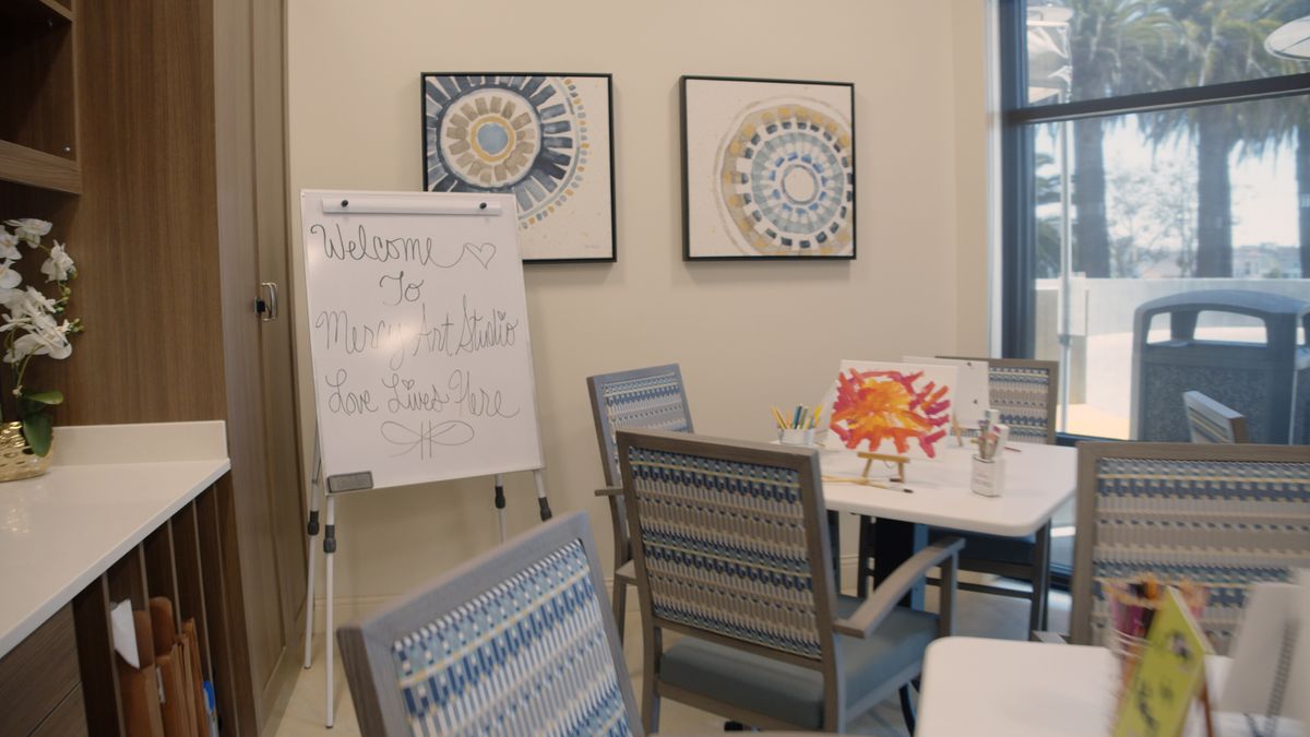 Interior view of Mercy Retirement & Care Center with dining area, classroom, and art-filled decor.