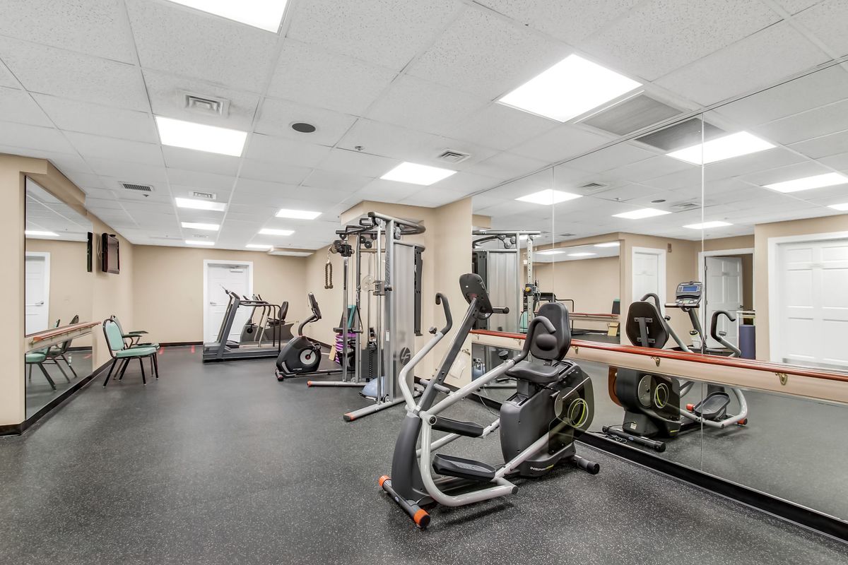 Seniors engaging in fitness activities at the gym in Brightwood Senior Living community.