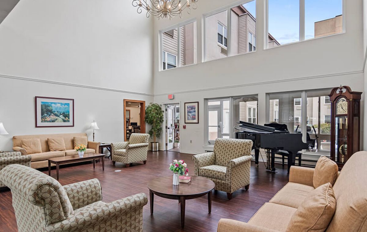 Interior view of Seaton Voorhees senior living community featuring a piano in the living room.