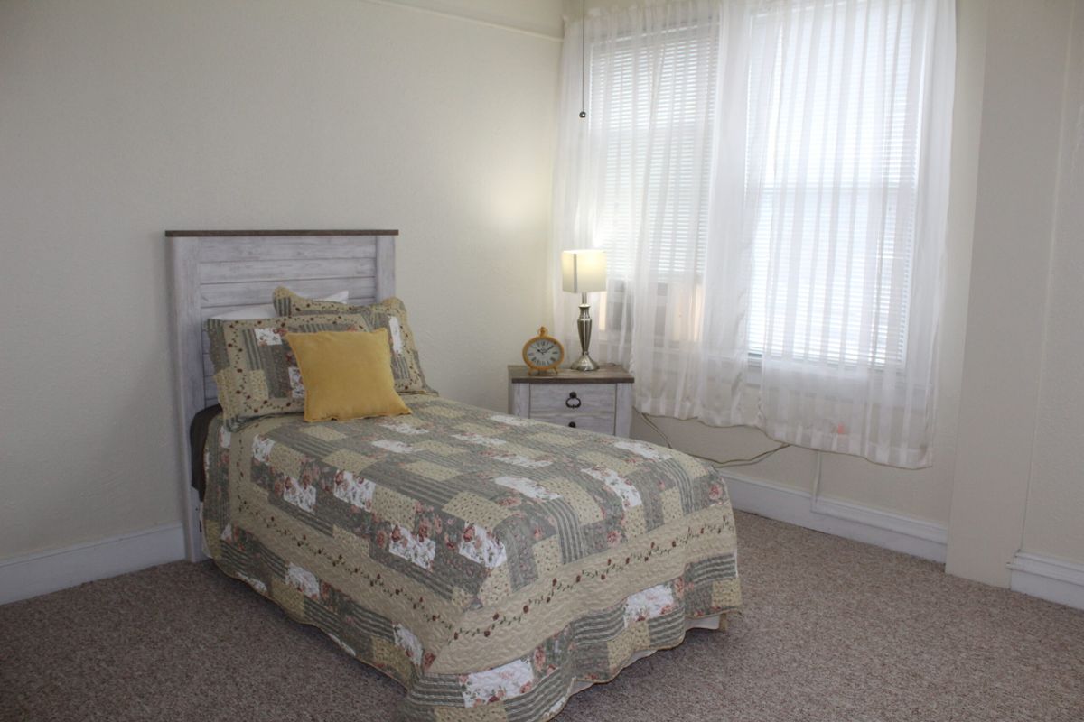 Interior view of a well-decorated bedroom at The Kensington Senior Living Community in Fort Madison.