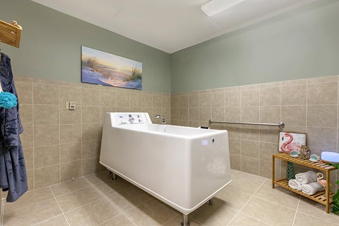 Senior resident enjoying a bath in a well-equipped bathroom at Brookdale Germantown community.