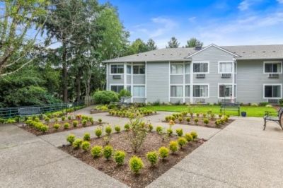 Regency Park Assisted Living and Memory Care facility in a suburban setting with lush greenery.