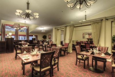 Regency Park Assisted Living and Memory Care facility featuring elegant dining room with chandelier.