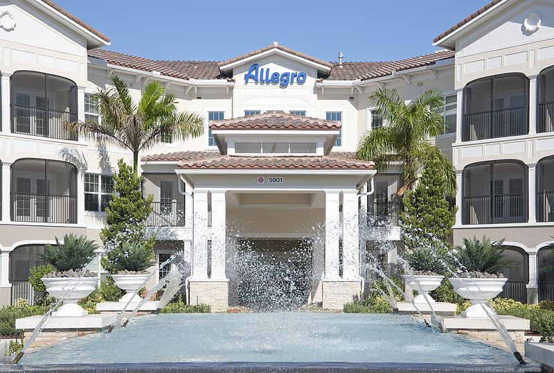 Allegro Parkland senior living community featuring resort-style villas, fountains, and lush plants.