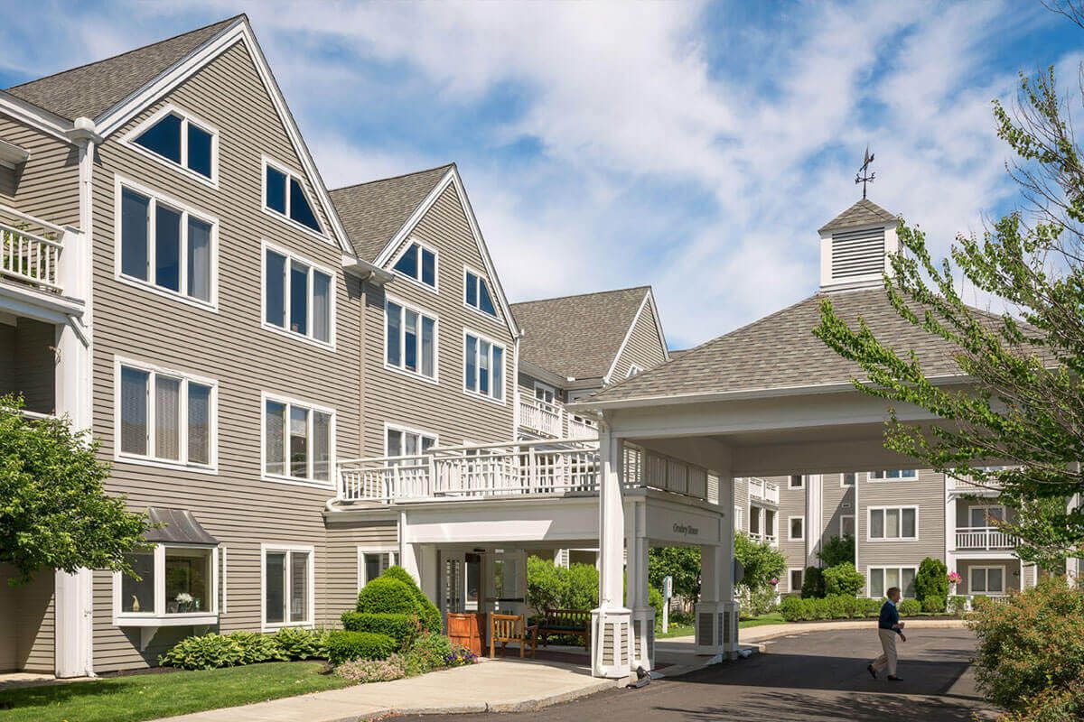 Senior living community, New Pond Village, featuring modern architecture in a suburban city setting.