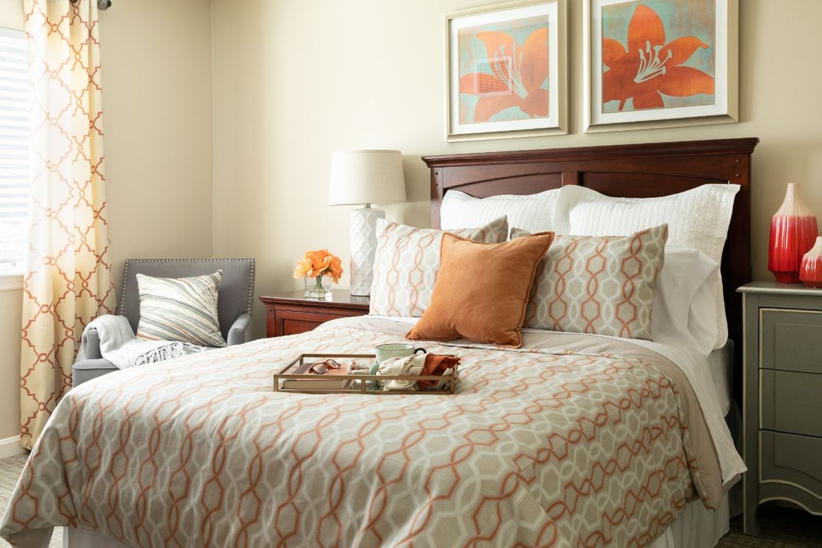 Interior design of a bedroom at Cushion Senior Living Community, featuring home decor and art.