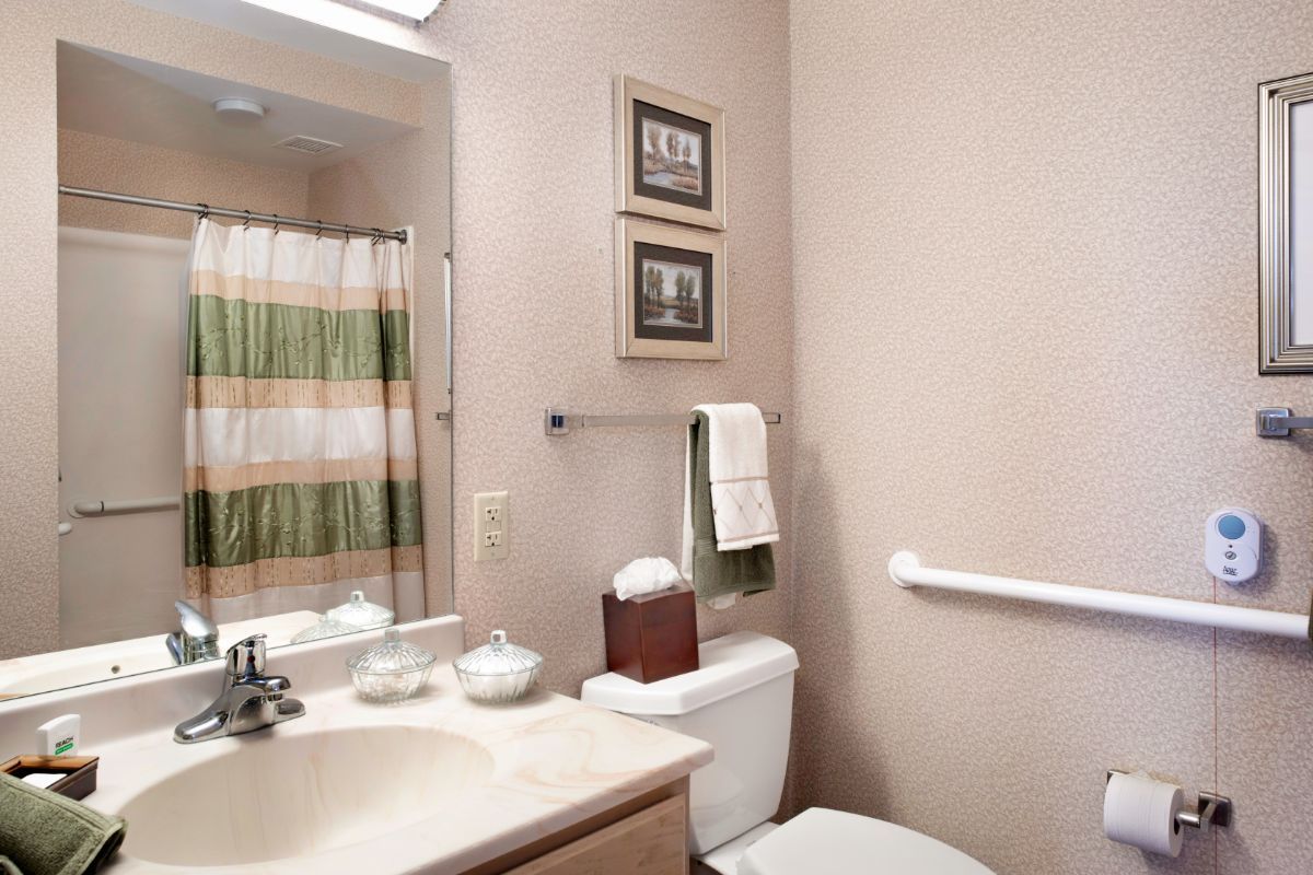 Senior living bathroom with sink, faucet, and toilet at Brighton Gardens of St. Charles.