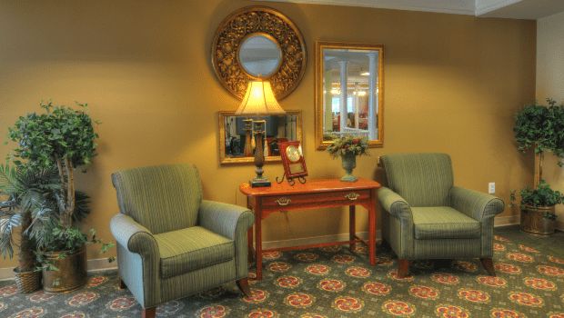 Interior view of Charter Senior Living of Gallatin featuring modern architecture, cozy furniture, and floral decor.