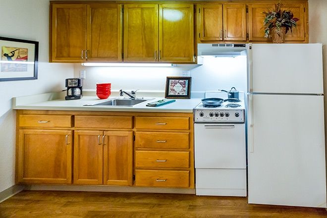 Senior living kitchen interior at Brookdale Redwood City with modern appliances and art.