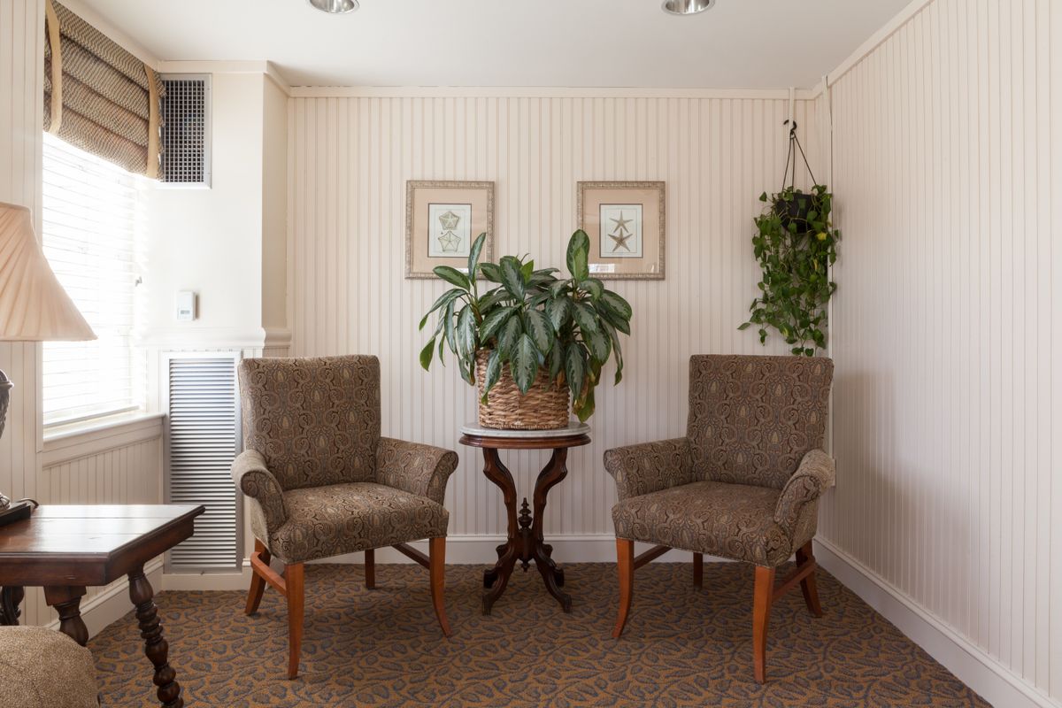 Interior view of Wentworth Senior Living with modern furniture, art, and indoor plants.
