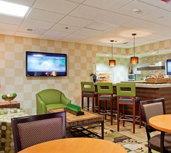 Senior living community, The Carlotta, featuring modern electronics, dining room, and home decor.