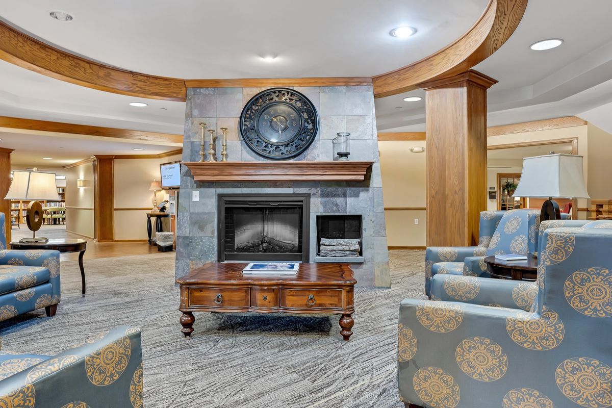 Senior living community room in Vestavia Hills with modern decor, electronics, and residents.