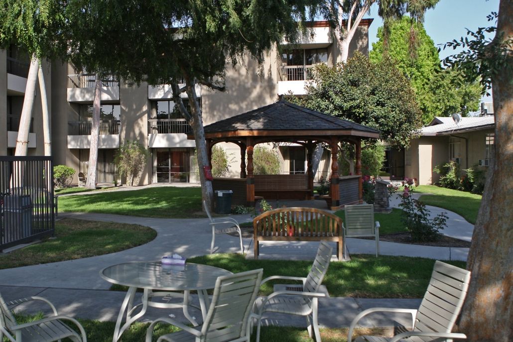 Southland Care Center's senior living community featuring a patio, pergola, and garden.
