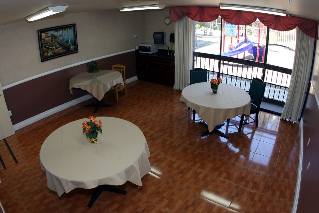 Interior view of Southland Care Center featuring hardwood floors, dining area, and modern appliances.