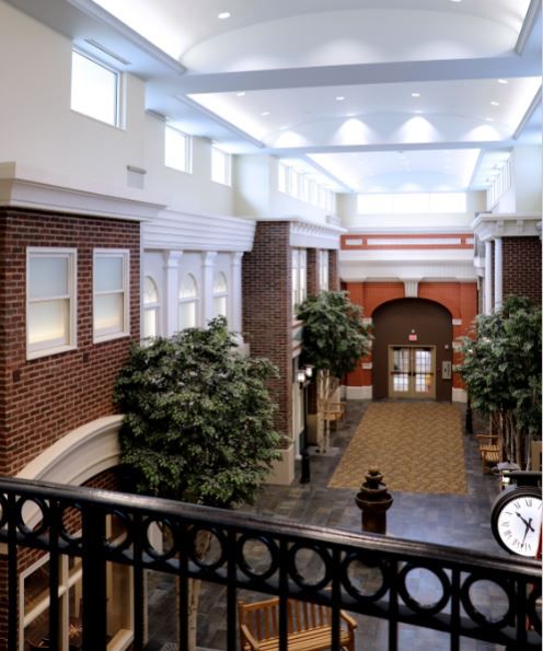 Interior view of Shannondale Health Care Center featuring arches, staircase, and skylight.