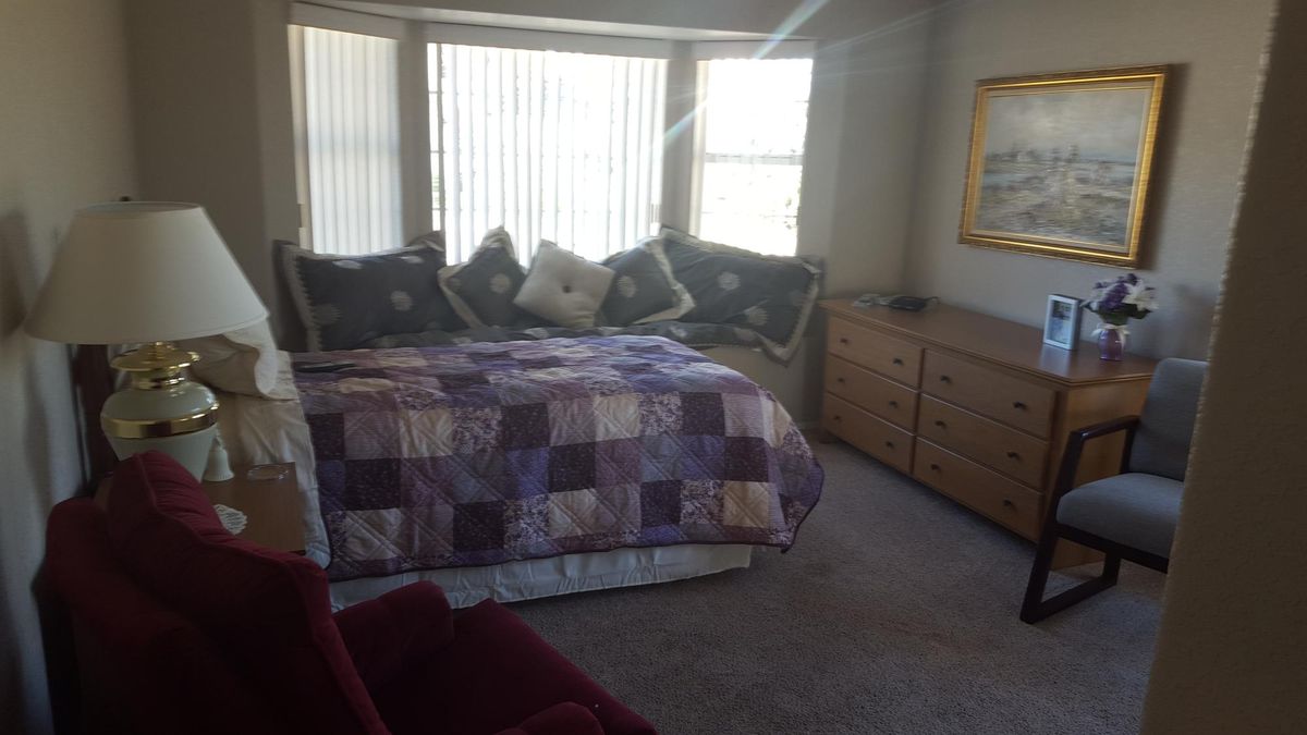 Interior view of a bedroom at Generations Senior Living, featuring tasteful decor, furniture, and art.