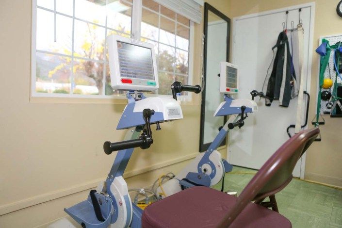 Seniors exercising in gym with modern equipment at Ukiah Post Acute Rehabilitation center.