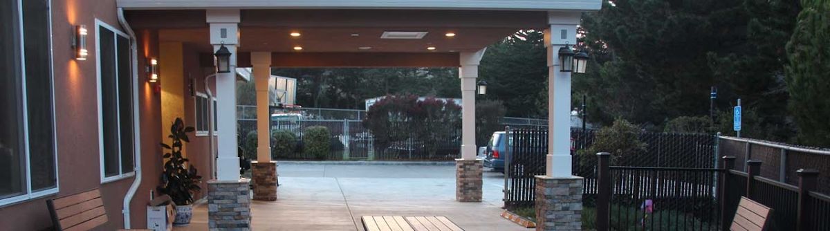 Senior living community with architectural buildings, indoor designs, porch, patio, and vehicles.