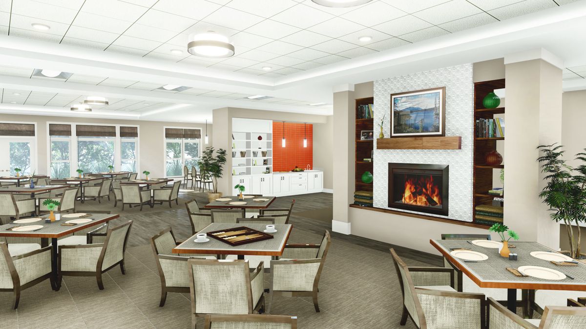 Interior view of Tiffany Springs Senior Living featuring dining area, lounge, and fireplace.