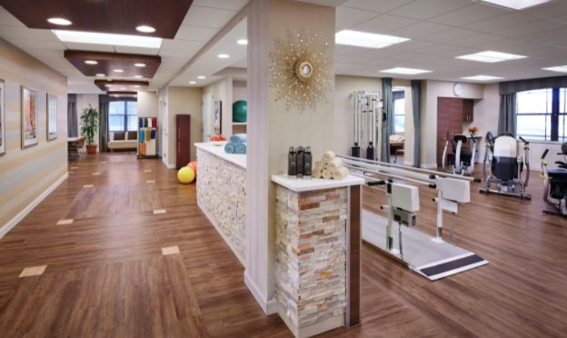 Interior view of Alden Des Plaines Rehab & Health Care's hardwood floored kitchen and foyer.