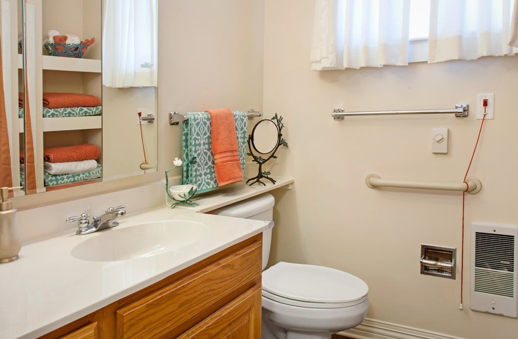 Corner bathroom with sink and faucet in Sunrise Assisted Living Home, Overland Park.