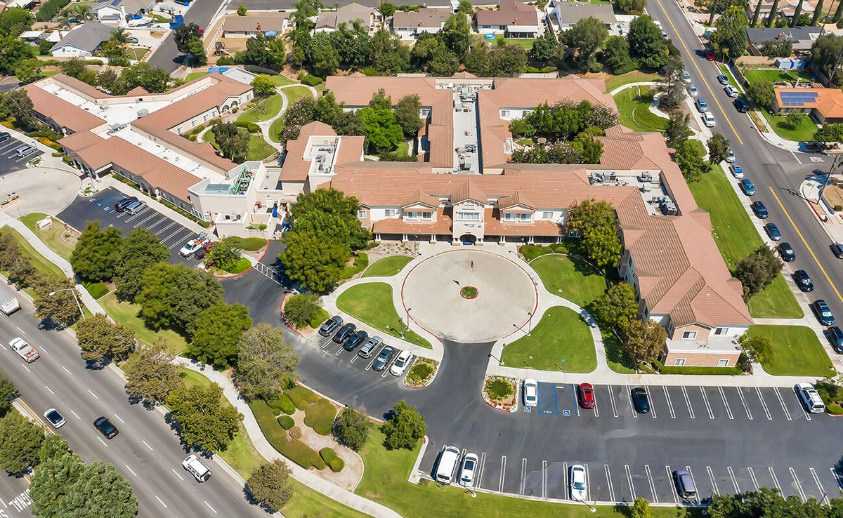 Aerial view of Serento Rosa senior living community in urban downtown, featuring architecture and transportation.