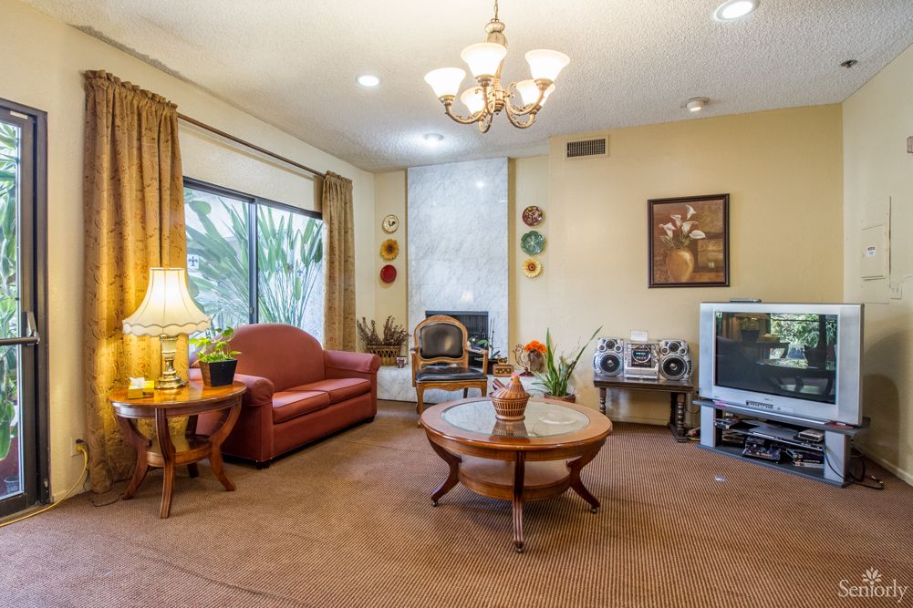 Interior view of Burbank Retirement Villa East featuring modern furniture, electronics, and home decor.