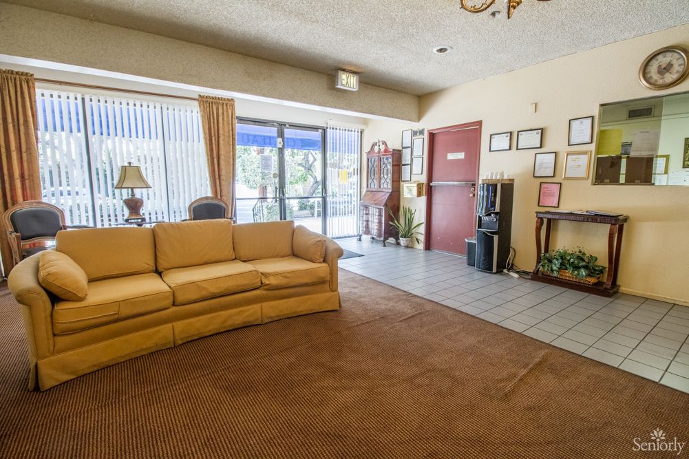 Interior view of Burbank Retirement Villa East featuring modern furniture, home decor and plants.
