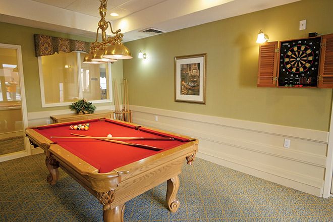 Senior living community Brookdale North Scottsdale featuring a furnished billiard room with pool table and chandelier.
