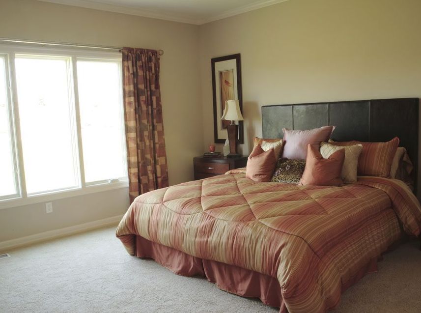 Interior view of a cozy bedroom in Independence Village senior living community.