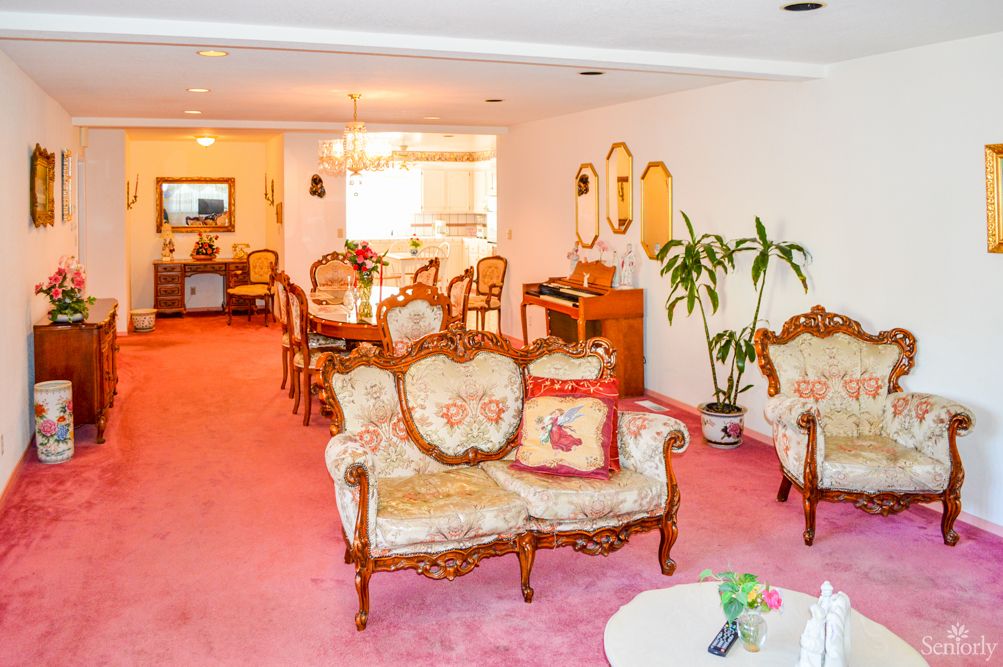 Interior view of Maria's Home For The Aged featuring a welcoming reception, cozy living and dining areas.