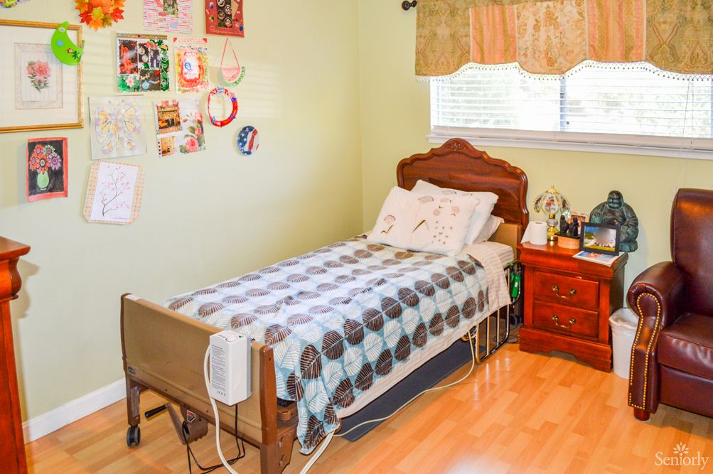 Senior resident relaxing in a well-furnished bedroom at Welcome Home Senior Residence-Alamo 3.