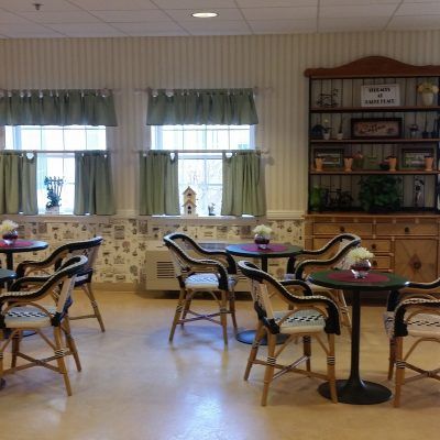 Senior living community interior at Terraces At Parke Place featuring dining area, library, and art.