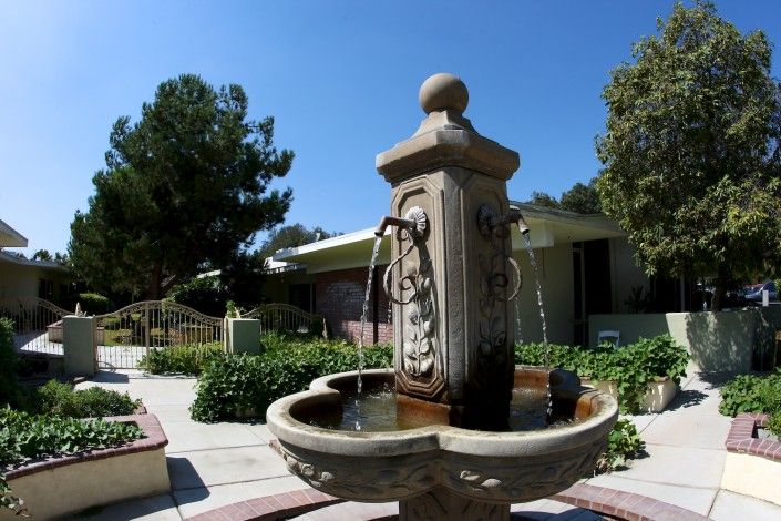Upland Rehabilitation and Care Center featuring villa-style housing, garden, fountain, and hot tub.