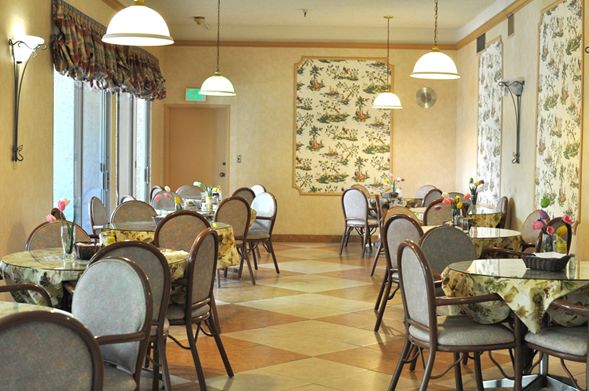 Interior view of Villa Sorrento senior living community featuring dining room and reception area.