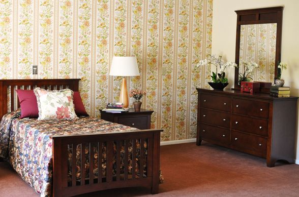 Interior design of a bedroom at Villa Sorrento senior living community with elegant furniture and decor.