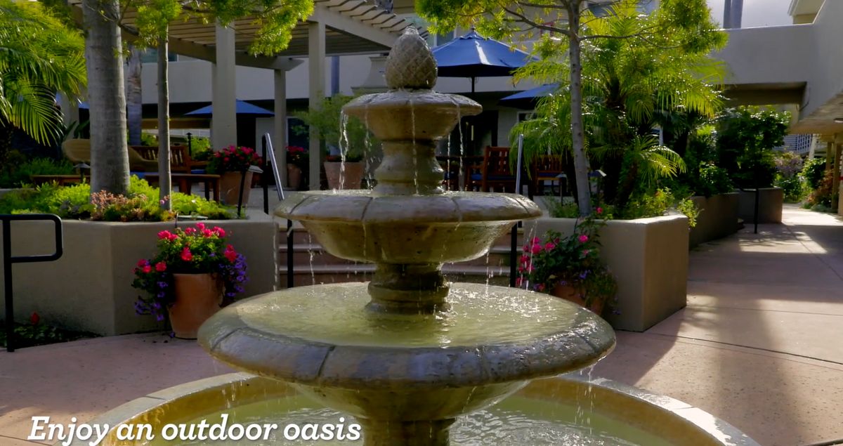 Senior living community in San Luis Obispo featuring resort-style villas, gardens, and a fountain.
