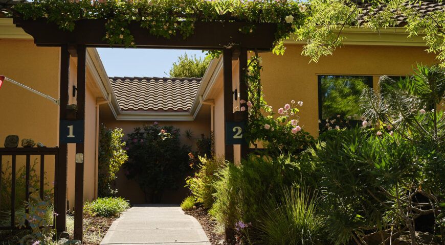 Senior living community, The Forum at Rancho San Antonio, featuring lush gardens and elegant architecture.